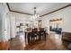 Open-concept dining area featuring hardwood floors and modern lighting fixtures with an adjacent kitchen at 4951 Center Hill Church Rd, Loganville, GA 30052