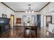 Elegant dining room featuring whitewashed walls, hardwood floors, and a vintage black wood burning stove at 4951 Center Hill Church Rd, Loganville, GA 30052