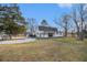 Charming home featuring a well-maintained exterior, an open backyard, and gravel driveway at 4951 Center Hill Church Rd, Loganville, GA 30052