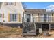 Welcoming home entrance with a black door, dark wooden steps, and traditional wood shutters at 4951 Center Hill Church Rd, Loganville, GA 30052