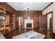 Cozy living room with a fireplace, custom built-in shelves, beautiful hardwood floors and natural light at 4951 Center Hill Church Rd, Loganville, GA 30052