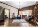 Cozy living room with hardwood floors, a bay window, and a comfortable seating area at 4951 Center Hill Church Rd, Loganville, GA 30052