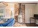 Cozy living area featuring brick accent and a wood burning stove, and views of outdoor nature at 4951 Center Hill Church Rd, Loganville, GA 30052