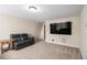 Relaxing living room featuring a comfortable leather sofa and modern media setup for entertainment at 4951 Center Hill Church Rd, Loganville, GA 30052