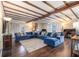 Large living room with exposed beams, wood floors, fireplace, and comfortable seating for Gathering and friends at 4951 Center Hill Church Rd, Loganville, GA 30052