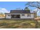 The home's rear exterior with covered patio and a generous yard creating an inviting outdoor space at 4951 Center Hill Church Rd, Loganville, GA 30052