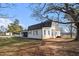 Rear view of home showcasing a spacious yard and inviting back porch, great for relaxation and entertaining at 4951 Center Hill Church Rd, Loganville, GA 30052