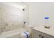 Bathroom featuring a marble-tiled shower and new fixtures at 1114 Oak Knoll Se Ter, Atlanta, GA 30315