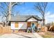 Charming one-story home with a blue front door, gray roof, and wooden porch at 1114 Oak Knoll Se Ter, Atlanta, GA 30315