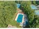 Aerial shot of a community pool, playground, and tennis courts nestled among green trees at 845 Connell Ln, Lawrenceville, GA 30044