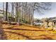 Large, inviting backyard featuring a trampoline, play slide, and home with neutral siding at 845 Connell Ln, Lawrenceville, GA 30044