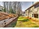 Expansive backyard with lush green grass, bordered by a retaining wall, and the home's exterior at 845 Connell Ln, Lawrenceville, GA 30044