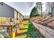 Backyard featuring a wooden deck, lush landscaping, wooden fence, and gray siding on the home at 845 Connell Ln, Lawrenceville, GA 30044