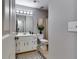 Well-lit bathroom with white cabinetry, modern toilet, and decorative mirror at 845 Connell Ln, Lawrenceville, GA 30044