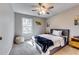 Cozy bedroom with neutral walls, carpet, and a large window offering natural light at 845 Connell Ln, Lawrenceville, GA 30044