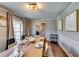 Traditional dining room with hardwood floors, decorative molding, and a modern light fixture at 845 Connell Ln, Lawrenceville, GA 30044