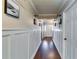 Inviting hallway with hardwood floors, white wainscoting and modern lighting at 845 Connell Ln, Lawrenceville, GA 30044