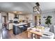 Eat-in kitchen features a kitchen island, stainless steel appliances, and modern lighting at 845 Connell Ln, Lawrenceville, GA 30044