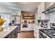 Well-equipped kitchen with stainless steel appliances, white cabinets, and open shelving at 845 Connell Ln, Lawrenceville, GA 30044