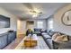 Living room featuring a large gray sectional sofa, ceiling fan, wooden coffee table, and hardwood floors at 845 Connell Ln, Lawrenceville, GA 30044