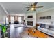 Cozy living room with a ceiling fan, fireplace, hardwood floors, and natural light from the window at 845 Connell Ln, Lawrenceville, GA 30044