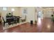 Cozy dining area with dark wood floors, table, and plush chair beneath a neutral-toned wall at 164 Charolais Dr, Mcdonough, GA 30252