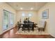 Dining area featuring wood floors, natural light, and a charming dining set at 164 Charolais Dr, Mcdonough, GA 30252