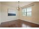 Bright dining room with hardwood floors, a modern chandelier, and large window at 164 Charolais Dr, Mcdonough, GA 30252