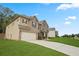 Spacious two-story home with attached garage, lush lawn, and a welcoming driveway at 164 Charolais Dr, Mcdonough, GA 30252