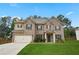 Charming two-story brick home with a well-manicured lawn and inviting entrance at 164 Charolais Dr, Mcdonough, GA 30252