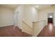 The hallway has neutral walls, wood floors, and access to various rooms at 164 Charolais Dr, Mcdonough, GA 30252