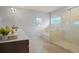 This renovated main bathroom includes double sinks, a stand-up shower, and a tub at 164 Charolais Dr, Mcdonough, GA 30252