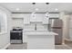 Bright, modern kitchen with stainless steel appliances and a center island at 2106 Singer Way, Lithonia, GA 30058