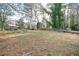 Large backyard with a seating area surrounded by beautiful mature trees at 2198 Star Mist Sw Dr, Atlanta, GA 30311