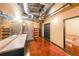 Industrial bathroom with double vanity, open shelving, pebble-stone shower, and exposed ductwork and pipes at 319 Atlanta Se St # 110, Marietta, GA 30060