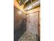 Close up of walk-in shower with stone floors, gray tile and wood paneling at 319 Atlanta Se St # 110, Marietta, GA 30060