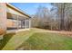 View of a home's brick exterior and covered porch from the backyard at 3257 Alhambra Cir, Hampton, GA 30228