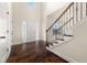 Bright foyer with hardwood floors, staircase, transom window above the front door, and white trim at 3257 Alhambra Cir, Hampton, GA 30228