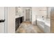 Bathroom featuring double vanity, soaking tub, tiled floor, and a doorway to the closet at 3257 Alhambra Cir, Hampton, GA 30228