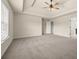 The primary bedroom features a spacious layout, tray ceiling with a ceiling fan, carpet, and natural light at 3257 Alhambra Cir, Hampton, GA 30228