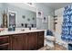 This bathroom features a vanity with a dark wood cabinet, white countertop, toilet, and shower-tub combination at 5019 Lower Elm St, Atlanta, GA 30349