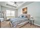 Comfortable bedroom with a queen bed, ceiling fan, carpeting, and a window for natural light at 5019 Lower Elm St, Atlanta, GA 30349