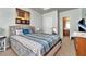 Well-lit bedroom with a queen bed, carpeting, ensuite bathroom, and neutral color palette at 5019 Lower Elm St, Atlanta, GA 30349