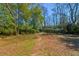 Serene backyard featuring a stone pathway leading through lush greenery and mature trees at 565 Candler St, Atlanta, GA 30307