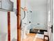 Modern bathroom with a glass-enclosed shower, pedestal sink, and rustic wooden accents at 565 Candler St, Atlanta, GA 30307