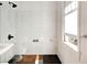 Bathroom showcasing a glass-enclosed shower with sleek tiling and modern fixtures, complemented by natural light at 565 Candler St, Atlanta, GA 30307