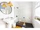 Clean bathroom featuring glass shower, dark tile, white vanity, and natural lighting at 565 Candler St, Atlanta, GA 30307