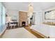 Stylish bedroom with hardwood floors, a brick fireplace, a white bed, and natural light from the large window at 565 Candler St, Atlanta, GA 30307