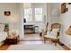 Bedroom featuring hardwood floors, white walls, a sitting area, and large windows providing natural light at 565 Candler St, Atlanta, GA 30307