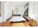 Bright bedroom with hardwood floors, simple decor, and natural light at 565 Candler St, Atlanta, GA 30307